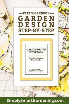 the garden design workbook is sitting on top of a table with scissors and paper