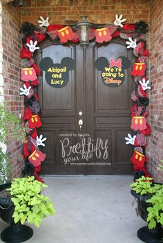 the front door to mickey mouse's house is decorated with red and black decorations