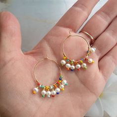 Rainbow earrings, colorful earrings, beach jewelry, big hoop earrings, modern jewelry, mothers day gift, freshwater pearl hoop earrings, wire wrapped earrings, cute earrings, summer jewelry, unique earrings, rainbow jewelry, 24K gold filled hoop. Modern trendy beach jewelry. These rainbow earrings look like a piece you might pick up on vacation. Wear them with everything from a T-shirt and jeans to your favorite swimsuit. HIGH QUALITY MATERIALS / SIZE 24-karat gold filled 20mm hoops wire wrapped Handmade 14k Gold Filled Earrings For Beach, Colorful Handmade Hoop Earrings For Summer, Handmade 14k Gold Filled Beach Earrings, Handmade Rainbow Hoop Earrings For The Beach, Colorful Hoop Earrings For The Beach, Rainbow Drop Earrings For The Beach, Handmade Colorful Summer Hoop Earrings, Rainbow Drop Earrings For Beach, Gold Hoop Earrings With Colorful Beads For Beach