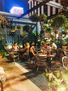 people sitting at tables in an outdoor restaurant