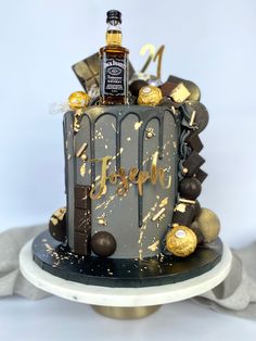 a birthday cake decorated with chocolate and gold decorations