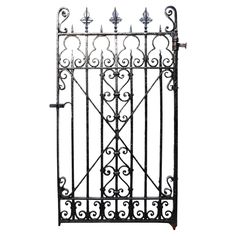 an iron gate with ornate designs on the top and bottom bars, set against a white background