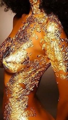 a woman with gold paint on her body