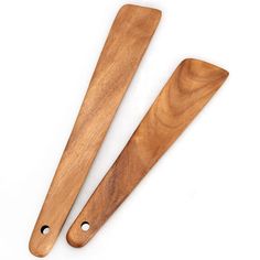 two wooden utensils sitting next to each other