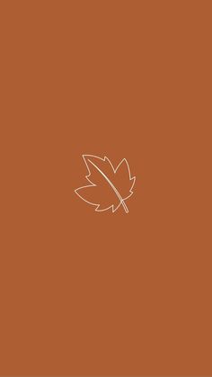 an orange background with a leaf on it