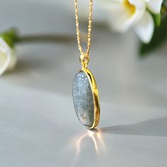 This exquisite pendant showcases a stunning labradorite stone, renowned for its captivating play of colors. The focal point of this piece is the labradorite's mesmerizing multicolored pink/purple flash, a rare and enchanting phenomenon that catches the light beautifully, revealing a spectrum of iridescent hues. Specifications: Stone type: Natural Labradorite Bail Material: 18K Gold Chain Material: Chosen Upon Checkout  Bezel Material: 18k gold-plated 925 silver Condition: Excellent Weight: 11.8 grams Encased in a luxurious gold-plated 925 sterling silver bezel, the pendant boasts a perfect balance of elegance and durability. The solid 18k gold bail adds a touch of opulence, securely holding the pendant while seamlessly integrating with the design. Paired with a matching gold chain, the ent Gold Labradorite Oval Pendant Necklace, Gold Oval Pendant Necklace In Labradorite, Gold Oval Labradorite Necklaces, Gold Oval Labradorite Necklace, Gold Labradorite Gemstone Necklace, Oval Gold Labradorite Necklace, Gold Labradorite Necklaces As Gift, Gold Labradorite Necklaces For Gifts, Gold Labradorite Necklace For A Gift