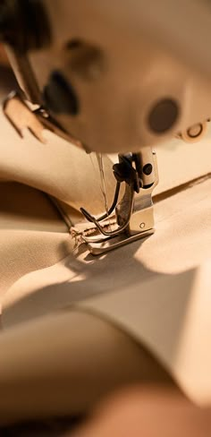 the sewing machine is stitching fabric together