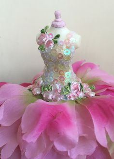 a dress made out of pink and green flowers