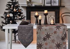 a table topped with candles next to a christmas tree