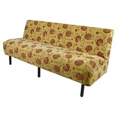 a yellow floral couch with black legs and an upholstered design on the back