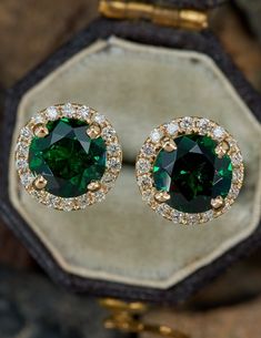 Round Emerald Earrings With Halo Setting, Emerald Earrings With Halo Setting, Exquisite Tsavorite Jewelry For Anniversary, Emerald Halo Setting Round Earrings, Timeless Tsavorite Green Jewelry, Green Round Earrings With Halo Setting, Formal Tsavorite Earrings Fine Jewelry, Exquisite Green Earrings With Prong Setting, Classic Green Halo Earrings