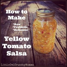 a jar filled with yellow tomato salsa sitting on top of a wooden table next to the words, how to make raw probiotic