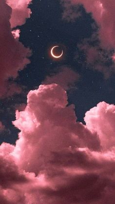 the moon is in the sky with clouds and stars around it, as well as some pink hues