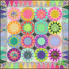 a colorful quilt with lots of different colored circles and stars on the front, along with dots