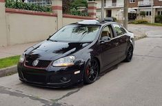 a black car is parked on the street