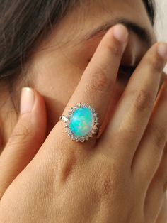 Product Details : ✦ Stone Name: Ethiopian Opal , Diamond ✦ Metal : 14 K Gold ✦ Shape of Gemstone : Oval ✦ Weight : Gold - 3.626 grm Diamond - 0.22 Carats Opal - 4.00 Carats It is a very royal yet super elegant blue opal gold ring with diamonds and best of hues. For more pieces like these visit https://www.etsy.com/in-en/shop/kanchanglobal?ref=seller-platform-mcnav&section_id=27149585 Your satisfaction is our priority ! ----------------------------- A great gift idea for: Birthdays Valentines Opal Ring With Diamond Accents For Gift, Hallmarked Oval Diamond Opal Ring, Gift Opal Ring With Diamond Accents, Opal Diamond Ring Fine Jewelry, Diamond Opal Ring Birthstone Fine Jewelry, Opal Diamond Ring Oval Cabochon, Diamond Opal Ring Oval Cabochon, Diamond Opal Cabochon Ring For Anniversary, Diamond Cabochon Opal Ring For Anniversary