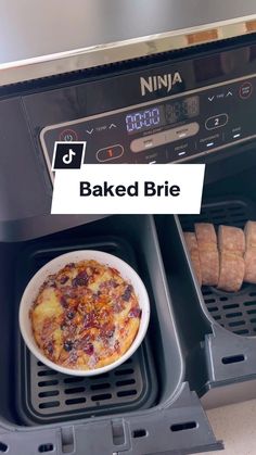 a bowl of food sitting inside of an oven