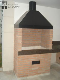 a brick oven sitting inside of a kitchen next to a wall mounted stove top oven