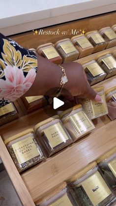 a person is touching some gold bars on a table