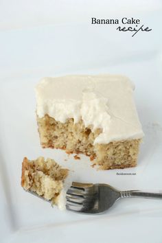 a piece of cake with white frosting sitting on a plate