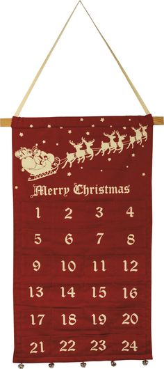 a red christmas calendar hanging from a wooden hanger with santa's sleigh on it