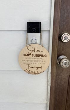 a wooden sign hanging on the side of a door saying, shh baby sleeping thank you