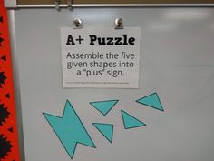 a white refrigerator with blue arrows on it and a sign that says at puzzle assemble the five given shapes into a'plus'sign