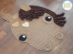 the rug is made to look like a cow's head with braids on it