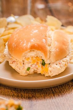 a chicken salad sandwich on a plate with chips