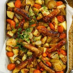 a tray filled with meat and vegetables on top of a table next to a basket