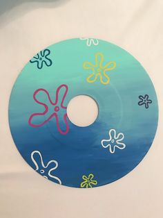 a cd with an octopus on it sitting on top of a white table next to a wall