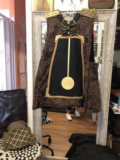 a coat is hanging on the wall in front of a mirror and some other items