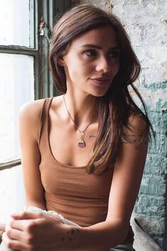 "Our cute little leather heart necklace is the perfect gift for so many ladies in your life: girlfriend, sister, daughter, mother or bridesmaids. This gold tone necklace features a brushed brass heart shaped pendant and is available in 40+ colors of our high quality genuine leather making them perfectly customizable too! Your heart necklace will arrive on an antique brass coated nickel free chain in the length of your choice. Size of Heart Charm: .75\" x .75\" Heart Pendant Drop Length: 1.75\" N Everyday Brass Jewelry With Heart Charm, Trendy Everyday Heart Pendant Charm Necklace, Everyday Adjustable Heart Pendant Charm Necklace, Everyday Charm Necklaces With Heart Pendant, Everyday Brass Heart Pendant Jewelry, Minimalist Brown Necklace For Everyday, Everyday Brown Brass Jewelry, Minimalist Brown Necklace For Everyday Use, Simple Necklace Everyday