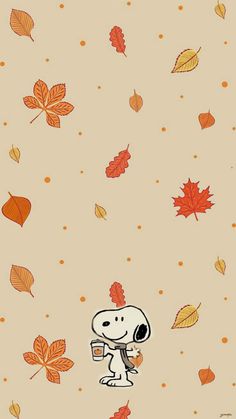 a cartoon snoopy with autumn leaves on the ground