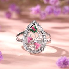 Reminiscent of the delicate garden, this ring has been carefully hand crafted in sterling silver, paying close attention to the intricate design of the flower. Bringing ring to life is cool leaf green and pink enamel detail. Bold on it own or great when paired with other complementary jewellery, this ring is incredibly versatile.Carat Weight: 2.25 ctStone Size: 1.5 mmNumber of Stones: 30 Stone Shape: RoundStone Color: Diamond WhiteWeight: 4.57 gWidth: 2.6 mmHeight: 6.1 mmThickness: 1.2 mmMaterial: 925 SilverPlating Color: Silver Pink Enamel Ring For Wedding, Pink Flower Enamel Ring For Wedding, Pink Flower Enamel Ring For Gift, Sterling Silver Flower Ring In Pink, Pink Flower-shaped Sterling Silver Ring, Pink Flower Sterling Silver Ring, Pink Flower Shaped Sterling Silver Ring, Sterling Silver Enamel Promise Ring, Fine Jewelry Enamel Ring In Silver As Gift