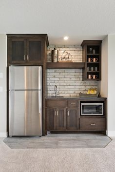 a kitchen with stainless steel appliances and wooden cabinets