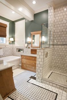 a bathroom with two sinks, a shower and a bathtub in it's corner