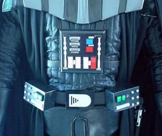 a darth vader costume is shown in black leather and has buttons on the chest