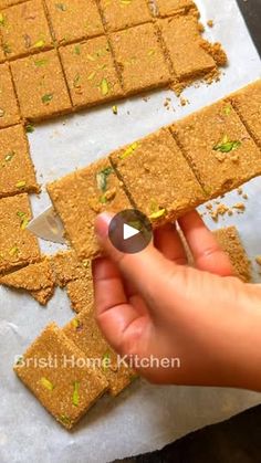 someone cutting up some food on top of a piece of parchment paper with a knife