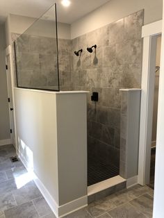 a walk in shower sitting inside of a bathroom