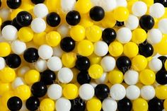 black, white and yellow beads are arranged in the shape of a ballon pattern