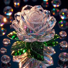 a crystal rose surrounded by lots of shiny glass balls and leaves on a black background