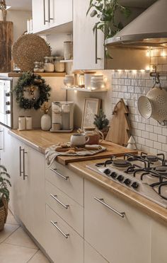 a kitchen filled with lots of counter top space and white cupboards next to a window