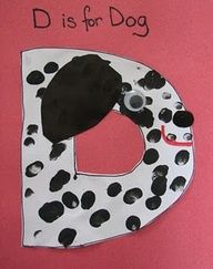 a paper plate with a black and white dog on it's letter d is for dog