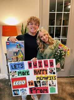 a man and woman holding up a sign that says build happy memories to each other