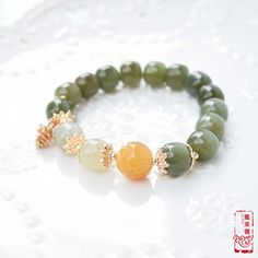 The bracelet selects natural Hetian nephrite jade beads with a round-barrel shape and green tone. Wearing jade jewelry for a long time will be beneficial to your body and make jade oily and bright. Round ornament represents completeness and happiness in Chinese culture. Therefore, ancient women were keen to wear bracelets to express their hope for a better life. Today, a piece of bangle still highlights the slenderness of the wrist, adding a woman's gentle temperament. It will bring you more coo Green Jade Gemstone Beads Bracelets, Green Jade Crystal Bracelet Spiritual Style, Green Hand-strung Jade Bracelets, Green Jade Crystal Bracelet For Spiritual Healing, Green Jade Bracelets With Round Beads, Jade Gemstone Beads Bracelets, Hand-strung Green Jade Bracelets, Jade Bracelet With Polished Beads, Jade Bracelets With Polished Beads