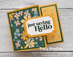 a close up of a card with flowers on it and the words just saying hello