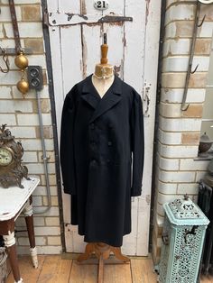 Antique French long black wool mourning morning jacket coat size M. 100% Wool.  Lapel with buttonhole, double breasted, chest pocket, inside pocket, cream striped cotton sleeve lining. Size: Chest: 40 inches; Shoulder to shoulder: 18 inches. Sleeve length: 25 inches; arm (inseam): 18 inches; Length: 40 inches.  Weight: allow up to 3 kg once packed. Good condition for its age. Vintage Black Double-breasted Pea Coat, Work Overalls, Cord Trousers, Wool Trousers, Cropped Trousers, Jacket Coat, Long Black, Black Wool, Inside Pocket