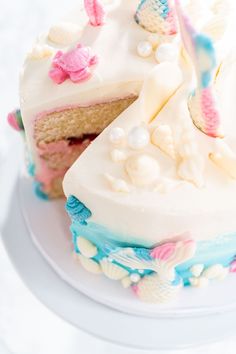 a piece of cake with white frosting and blue icing is on a plate