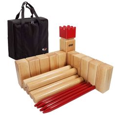 a set of red chopsticks sitting next to a black bag and some wooden blocks